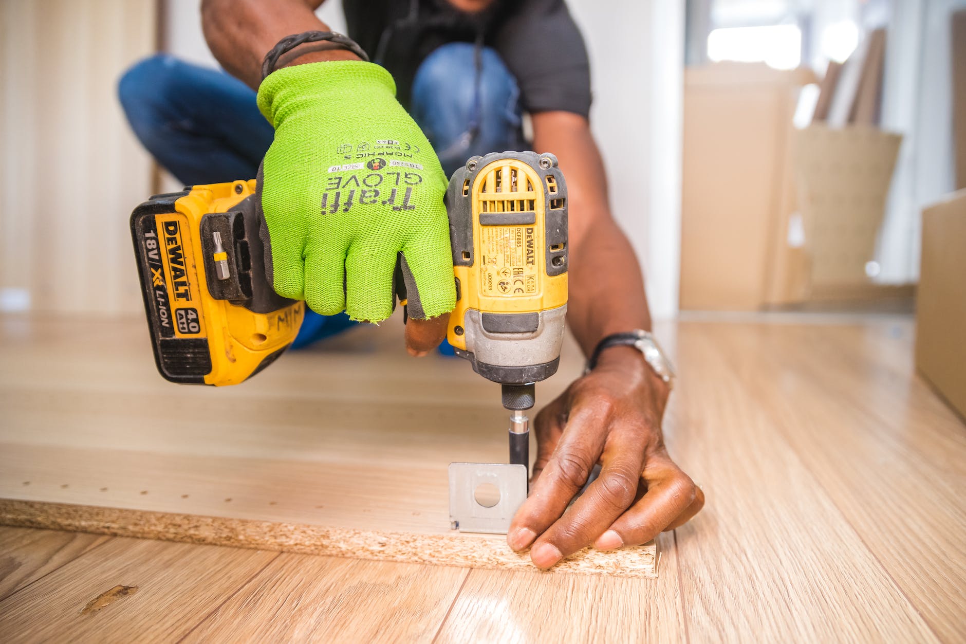 Man using a drill on a wooden door. 